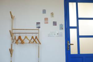 a closet with hangers and a blue door at Cube homestay Phan Rang cách biển 300m to the beach in Phan Rang