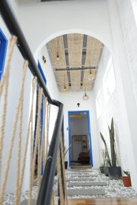 a hallway with stairs and a blue door at Cube homestay Phan Rang cách biển 300m to the beach in Phan Rang