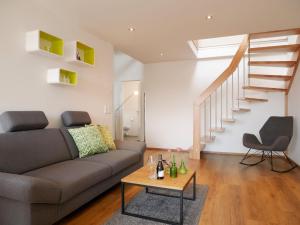 a living room with a couch and a table at Ferienhaus Dorfleben in Vogtsburg