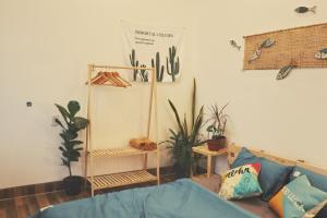 a living room with a couch and some plants at Cube homestay Phan Rang cách biển 300m to the beach in Phan Rang