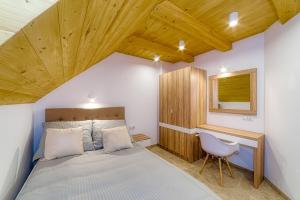 sypialnia z łóżkiem, biurkiem i krzesłem w obiekcie APARTAMENTY NA SKARPIE w mieście Szczawnica