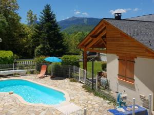 a swimming pool with a pavilion next to a house at Les FEICHES et MARGUERITES in Ignaux