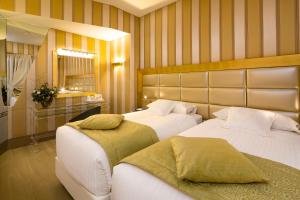 Giường trong phòng chung tại c-hotels Rubens
