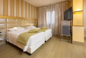 Giường trong phòng chung tại c-hotels Rubens