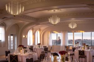 a banquet room with tables and chairs and chandeliers at Kimpton Cottonwood Hotel by IHG in Omaha +75 photos