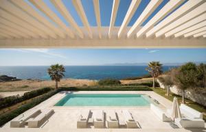 a swimming pool with a view of the ocean at PALMA BAY FRONT LINE in Llucmajor