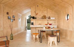 a kitchen and dining room with a table and chairs at Wikkelhuis 12 in Stavoren