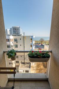 un balcón con 2 macetas en un edificio en Mayor Apartment Faleza Nord en Constanza
