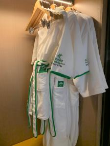 a group of white towels are hanging on a rack at Holiday Inn Shanghai Nanjing Road by IHG in Shanghai