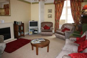 a living room with two couches and a tv at 29 High Street Dunster in Minehead