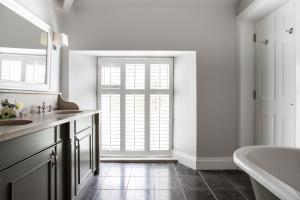 a bathroom with a tub and a large window at Millbrook Lodge in Ballynahinch