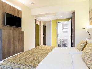 Кровать или кровати в номере Mercure Oostende