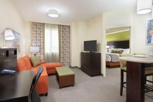 a hotel suite with a living room and a bedroom at Staybridge Suites - Miami International Airport by IHG in Miami