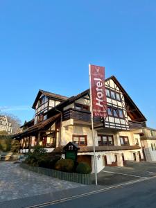 a building with a sign in front of it at Hotel Pension Berghaus Sieben in Bad Laasphe