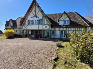 a hotel building with a gravel driveway in front of it at LA GRANDE BRUYERE in Touffréville