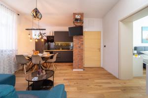 a kitchen and living room with a table and chairs at Apartman Letifico in Split