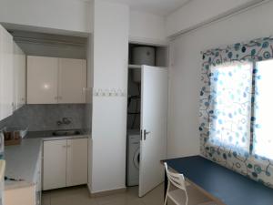 a kitchen with white cabinets and a blue and white curtain at 2 Bedroom apartment in Nicosia's center-11 in Nicosia