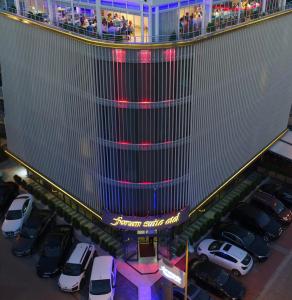 a car dealership with cars parked in a parking lot at Forum Suite Otel in Mersin