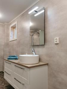 a bathroom with a sink and a mirror at Stuga Solbacken nära Rådasjön in Råda