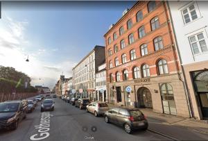 a city street with cars parked on the street at Gothersgade in Copenhagen