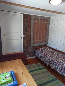 a bedroom with a bed and a door and a table at Laukkumäki farm in Iisalmi +7 photos