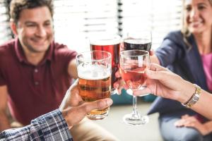 a group of people holding glasses of beer at Staybridge Suites - Miami International Airport by IHG in Miami