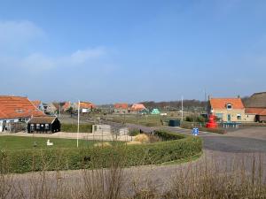 a view of a town with houses and a street at Onder de Pannen in Hollum