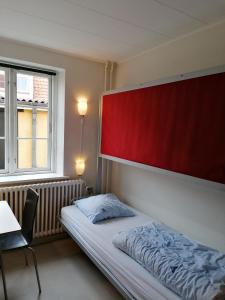 Postel nebo postele na pokoji v ubytování Femmasteren Hotel & Hostel