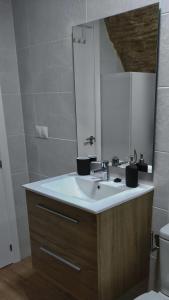 ein Bad mit einem Waschbecken und einem Spiegel in der Unterkunft Casa cueva La Tosca in Setenil de las Bodegas