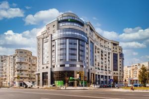 a large building on a city street at Holiday Inn Bucharest - Times by IHG in Bucharest