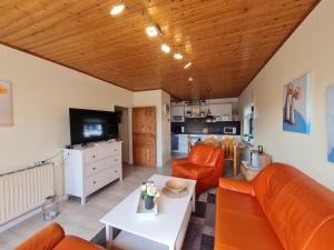 a living room with a couch and a table at Haus Seeheim in Böhl