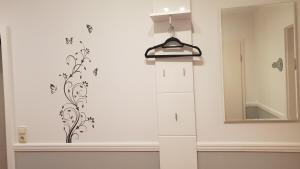 a room with a wall with a shelf and a mirror at Ferienwohnungen Eisenbarth in Schneverdingen +46 photos