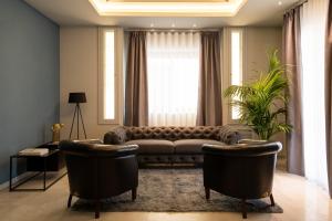 a living room with a couch and two chairs at Hotel Enzo in Porto Recanati +59 photos