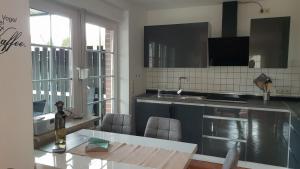 a kitchen with a sink and a counter top at Ferienwohnungen Eisenbarth in Schneverdingen