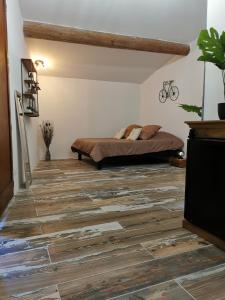 a bedroom with a bed and a wooden floor at Villa "La Crau" in Arles