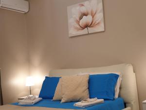 a living room with a couch with a flower painting on the wall at Oasi Iblea Inn in Ragusa
