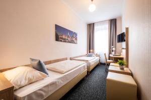 Postel nebo postele na pokoji v ubytování Hotel Jensen