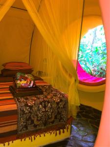 een bed in een tent met een raam bij Casa Corazon del Mar in Puerto Viejo