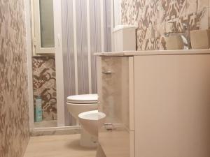 a bathroom with a white toilet and a shower at Oasi Iblea Inn in Ragusa