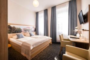 Postel nebo postele na pokoji v ubytování Hotel Jensen