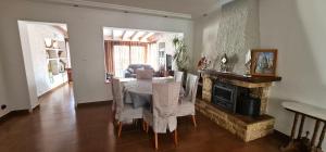 a dining room with a table and a fireplace at Villa Las Adelfas (escapada ideal en Costa Blanca) in Calpe