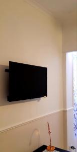 a flat screen tv on a wall in a living room at Al 68 Di Piazza Cavour in Naples