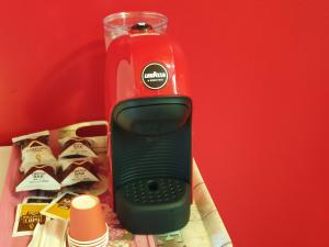 a red appliance sitting on top of a table at Oasi Iblea Inn in Ragusa +28 photos