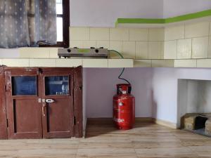a fire hydrant sitting in a room next to a fire hydrantccess at Prakriti's Nest in Almora
