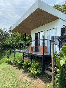 a house with a large deck in front of it at Cabaña miramar in Pereira