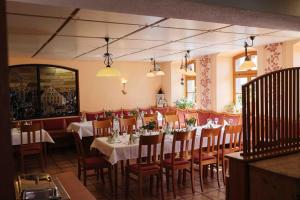 a dining room with tables and chairs in a restaurant at Landhotel Hohmann in Hilders