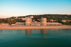 a beach with chairs and umbrellas and a resort at Azalia Beach Hotel Balneo & SPA in St. St. Constantine and Helena