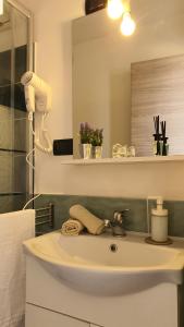 a bathroom with a sink with a phone on it at MataRoom in Torre Lapillo +49 photos