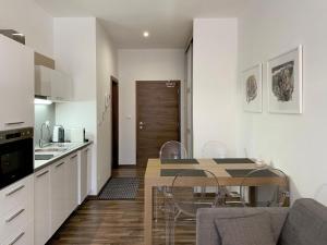 a kitchen and dining room with a table and chairs at No.1 Apartment House Oliver in Štrbské Pleso