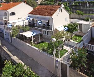 an overhead view of a house with blue signs on it at Nika Family Apartments in Dubrovnik
